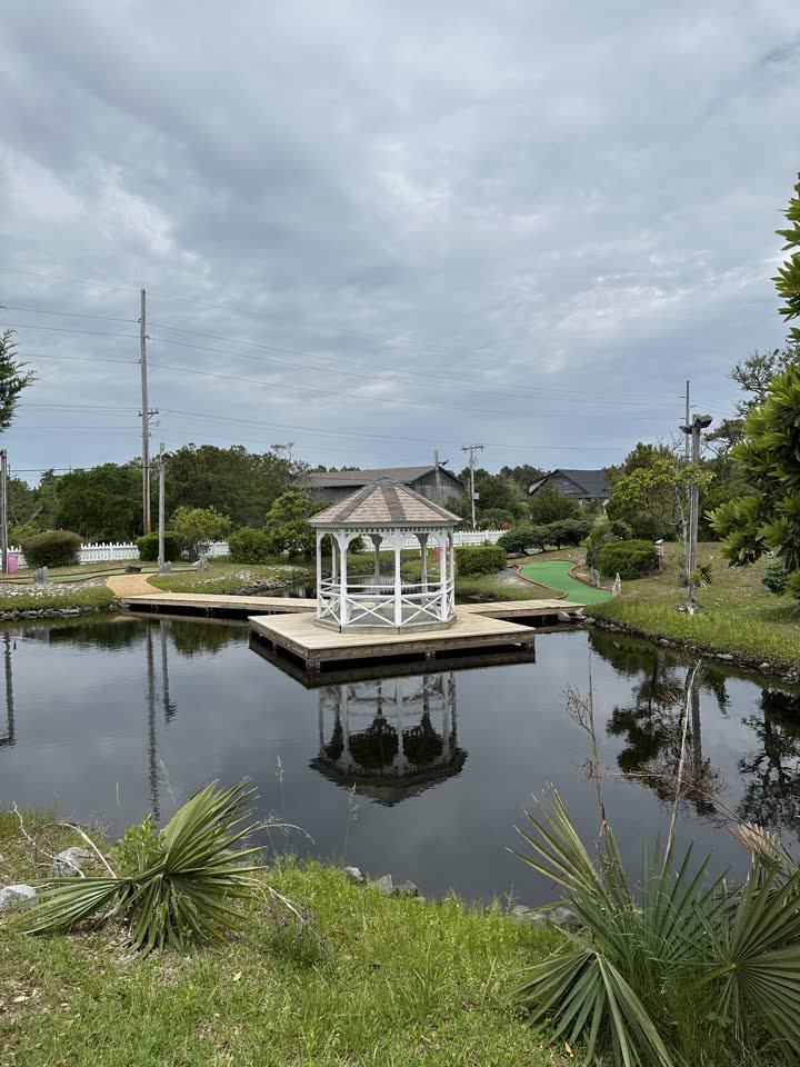 White gazebo on the pond boardwalk at Frisco Mini Golf