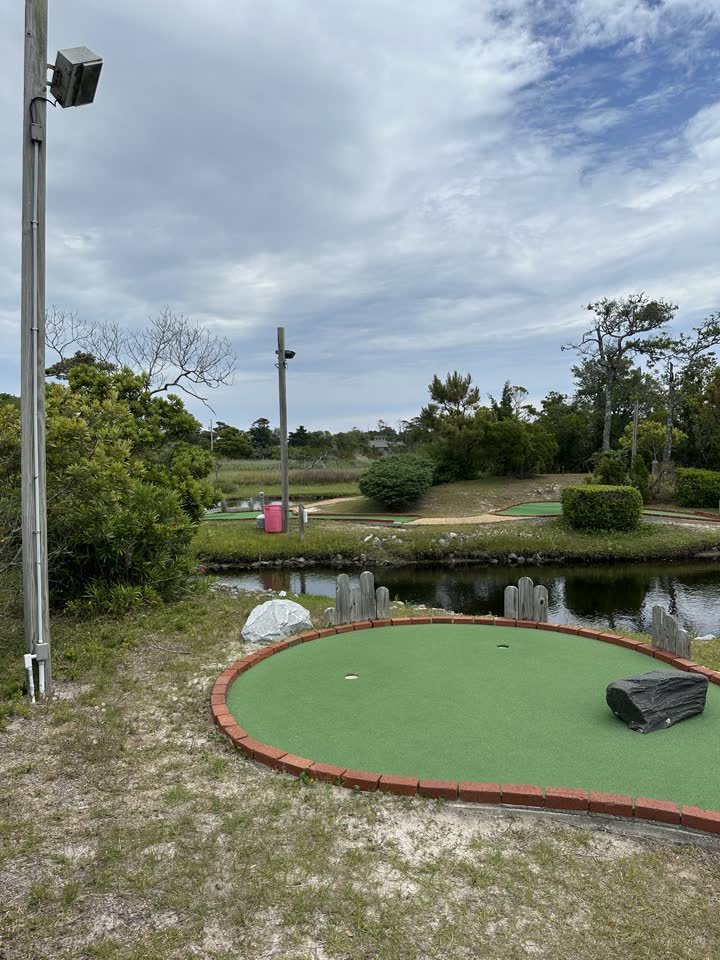 Mini golf green beside the pond under Outer Banks sky